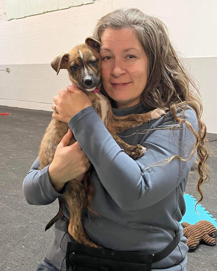 Caroline Ménard, intervenante en comportement canin, tenant un chiot dans ses bras